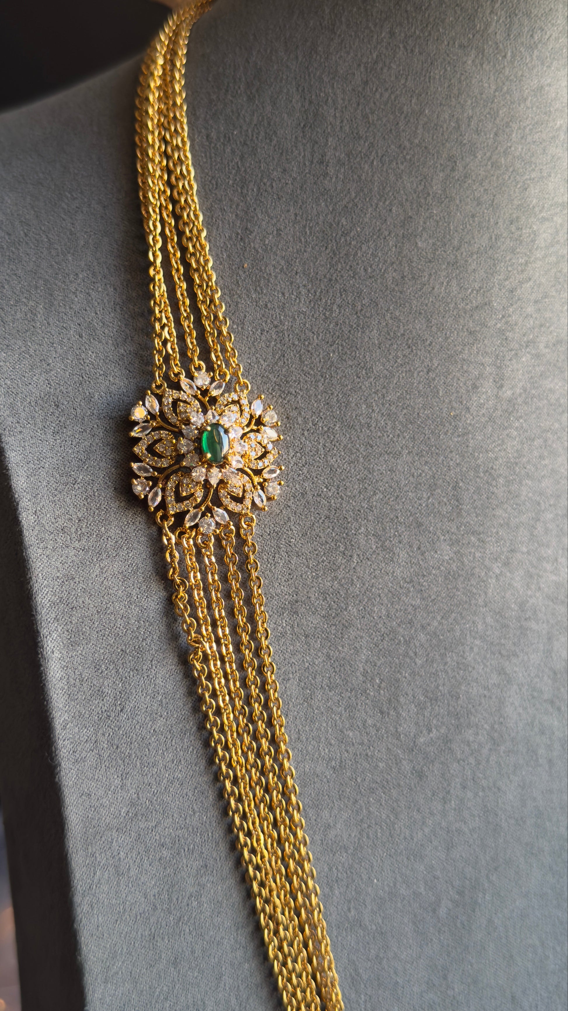 Gold chain with decorative clasp on a mannequin