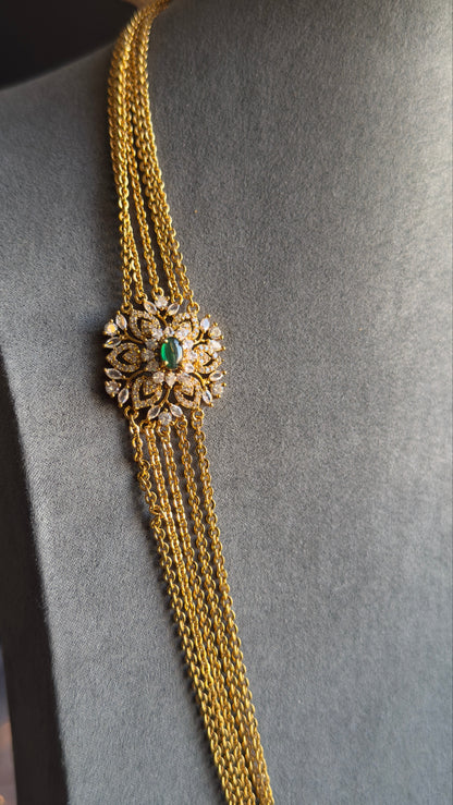 Gold chain with decorative clasp on a mannequin