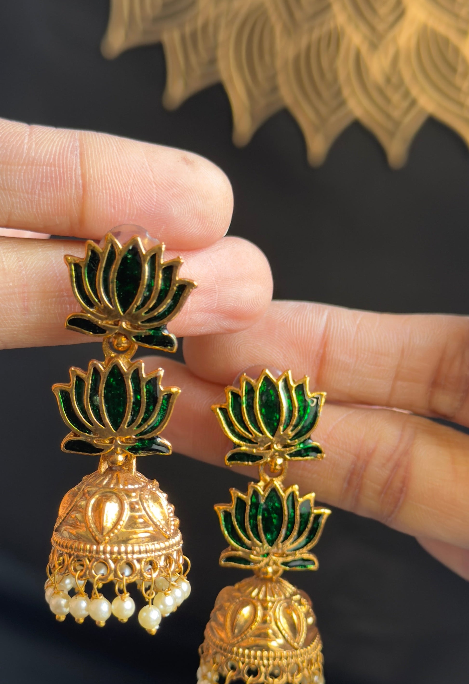 Traditional lotus green jhumka earrings featuring pearl drops and red detailing